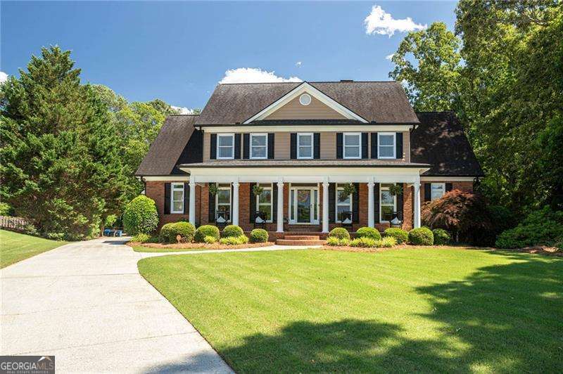a front view of a house with swimming pool having outdoor seating