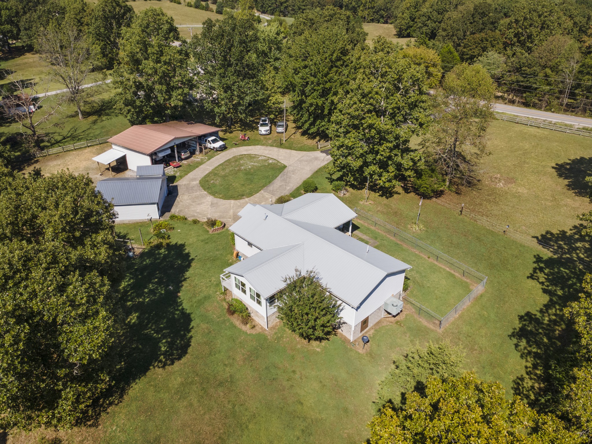 an aerial view of a house with a yard and lake view