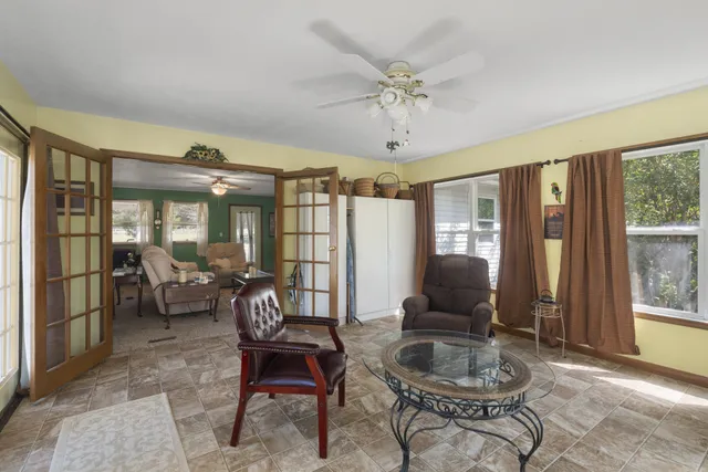 a living room with furniture and large windows