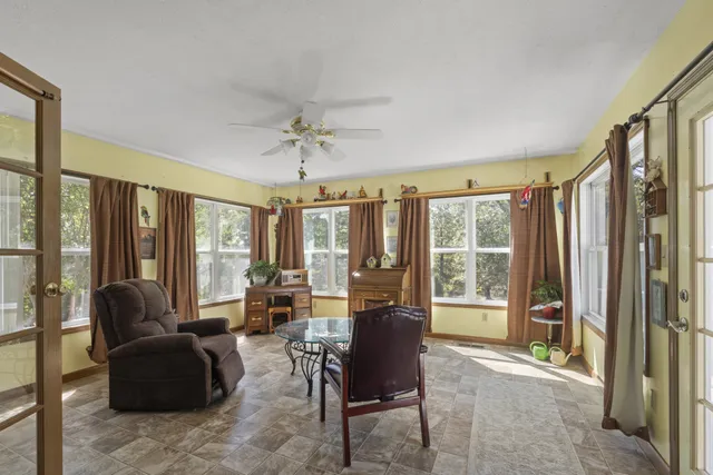 a living room with furniture and a large window with outer view