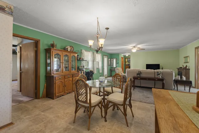 a living room with furniture a window and a flat screen tv