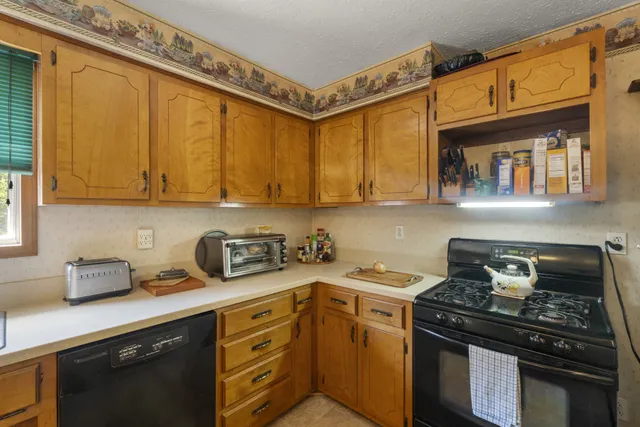 a kitchen with cabinets a sink and appliances