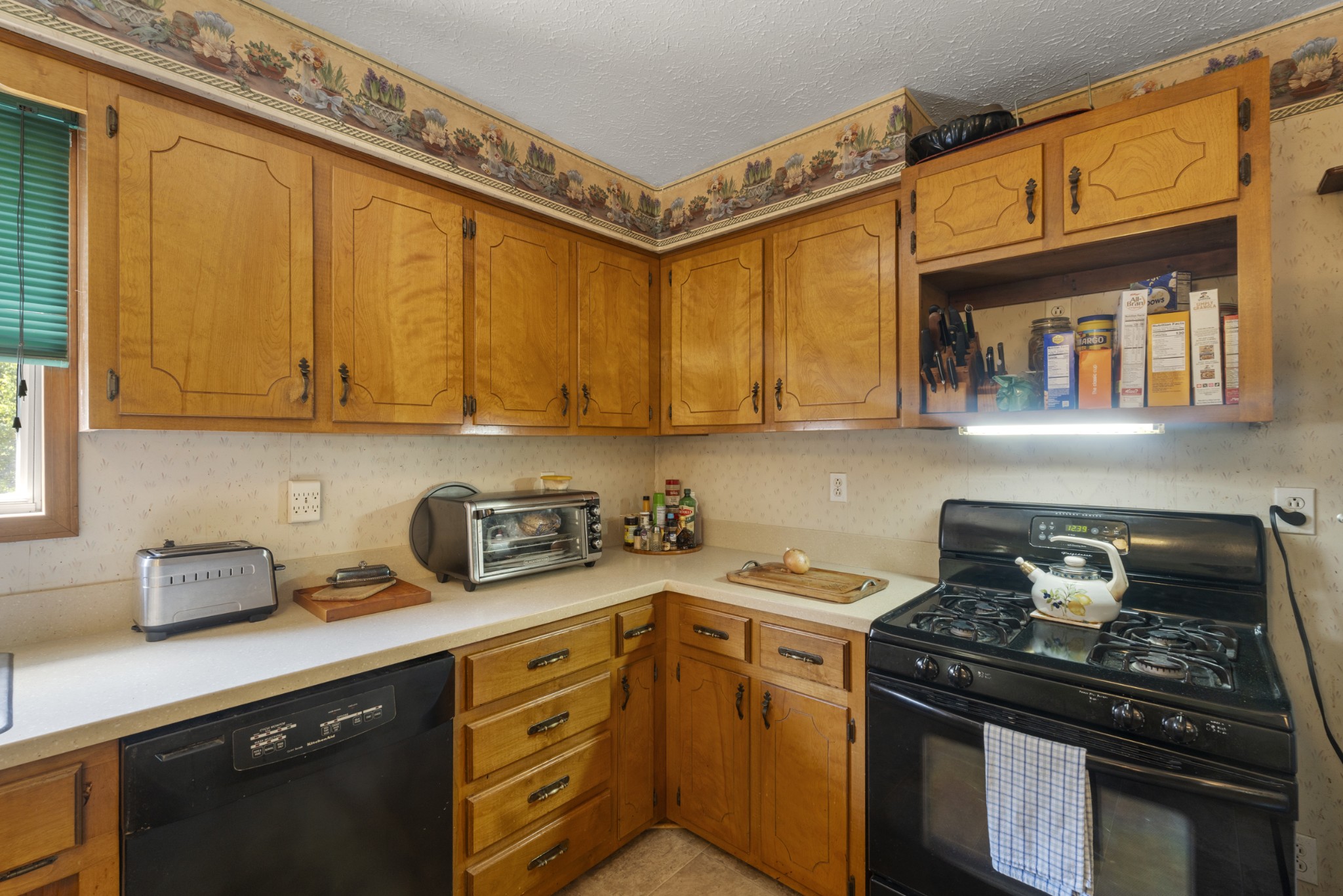3859 Erin Road McEwen, TN 37101 - Photo 34 of 52 a kitchen with stainless steel appliances granite countertop a stove a sink and cabinets