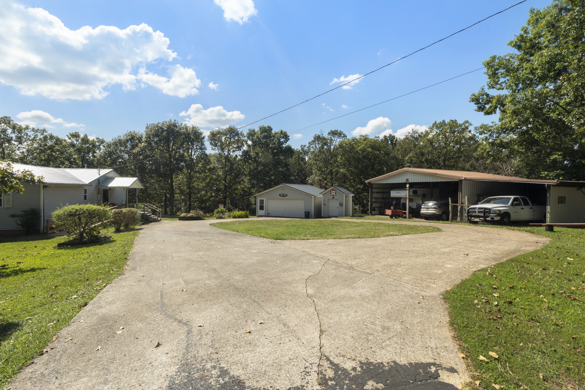3859 Erin Road McEwen, TN 37101 - Photo 9 of 52 a front view of a house with a garden and trees