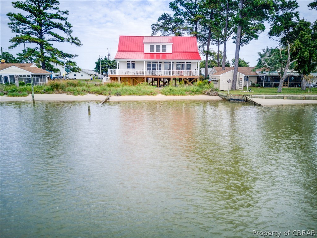 1237 Little Florida Road Farnham, VA 22460 - Photo 15 of 50 a view of a lake with a building and a big yard