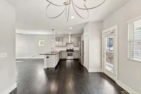 a view of a kitchen with a sink and wooden floor