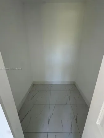a bathroom with a toilet sink vanity and mirror