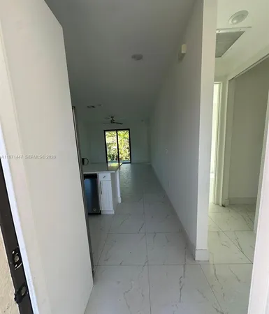 a large kitchen with a table chairs and refrigerator