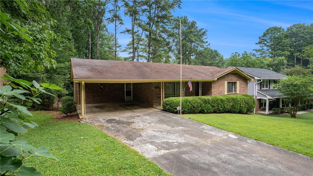 1230 Fork Creek Trail Decatur, GA 30033 - Photo 1 of 1 a front view of a house with a yard and garage