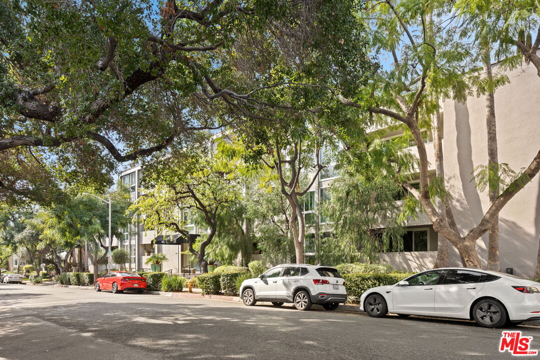 a view of cars parked on the side of a street