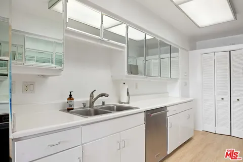 a kitchen with a sink and cabinets