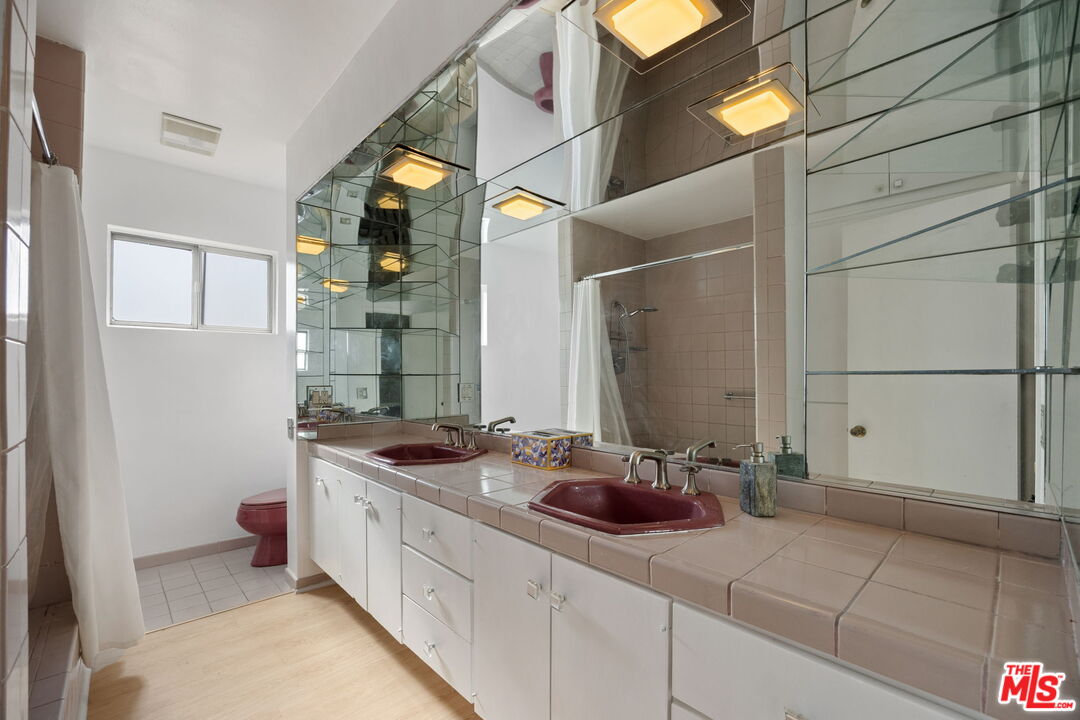 1025 North Kings Road, Unit 313 West Hollywood, CA 90069 - Photo 15 of 18 a bathroom with a sink and mirror