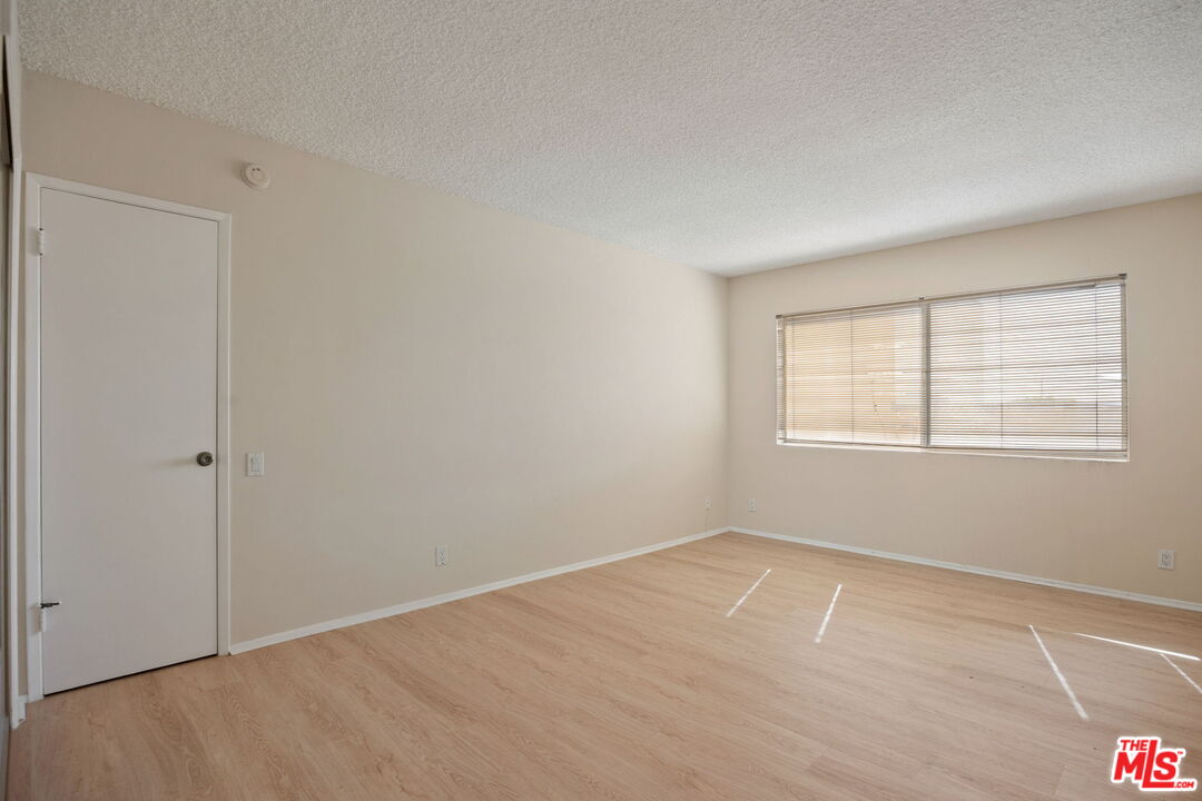 1025 North Kings Road, Unit 313 West Hollywood, CA 90069 - Photo 17 of 18 a view of an empty room with a window