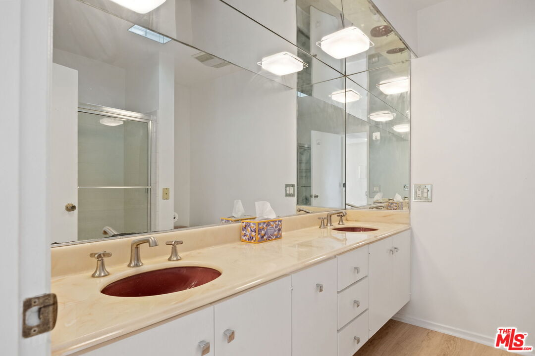 1025 North Kings Road, Unit 313 West Hollywood, CA 90069 - Photo 18 of 18 a bathroom with a sink and a mirror