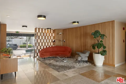 a bedroom with a bed and a potted plant