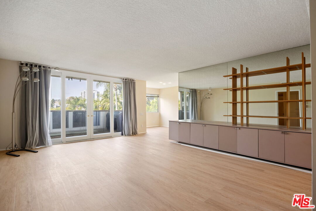 1025 North Kings Road, Unit 313 West Hollywood, CA 90069 - Photo 6 of 18 wooden floor in an empty room with a window