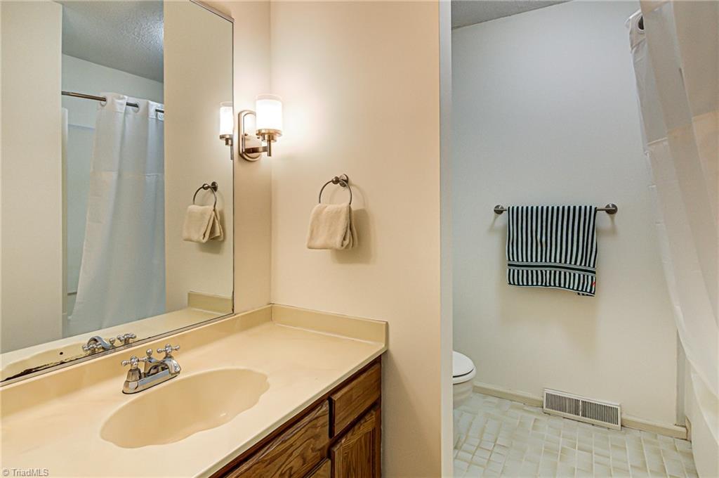 236 Northpoint Avenue, Unit F High Point, NC 27262 - Photo 19 of 25 The upstairs bath has plenty of counter space! The wall sconces create warm lighting that is perfect for getting ready!