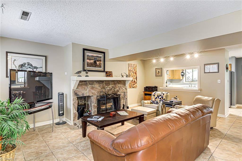 As soon as you walk in, you are welcomed by this bright, beautiful living room! Notice the track lighting above the breakfast bar.