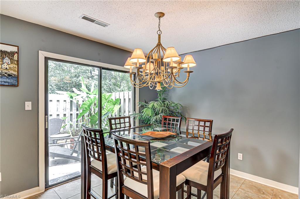 The dining room is naturally sunlit throughout most of the day! This is a great place to enjoy your morning cup of coffee! The sliding door leads to a the back patio. To the right of the dining room is a half bath.