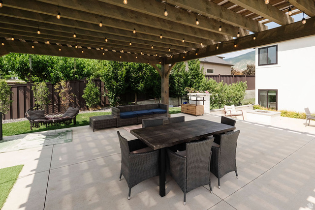 924 Country Lane Farmington, UT 84025 - Photo 89 of 91 Expansive concrete patio featuring a wood pergola with string lighting