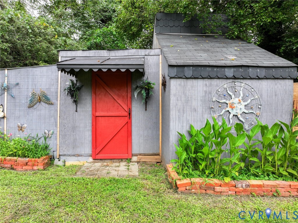 111 Whiteside Road Sandston, VA 23150 - Photo 40 of 45 Shed with gray siding and a red barn-style door, f