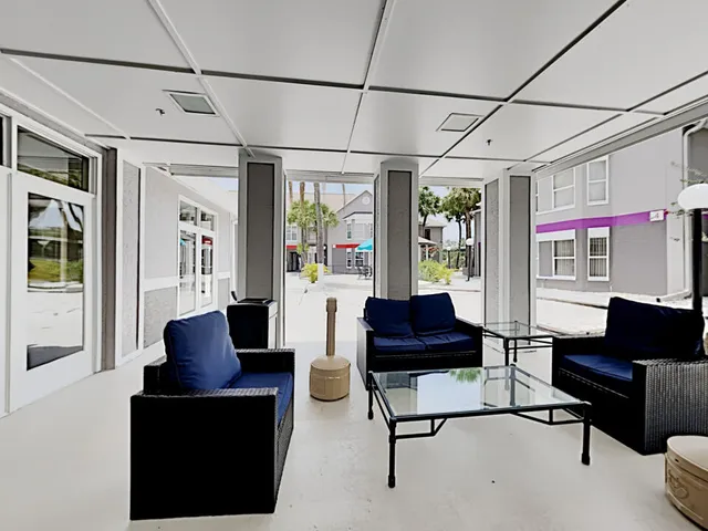 a living room with furniture a fireplace and a large window