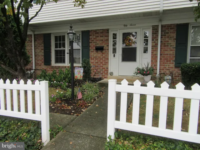 a view of a house with wooden fence