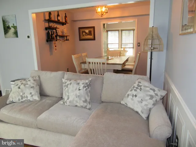 a living room with furniture and painting on the wall