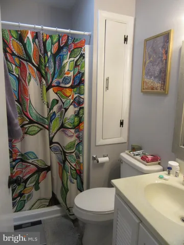 a bathroom with a sink mirror vanity and toilet