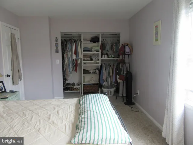 a bedroom with a bed and a mirror