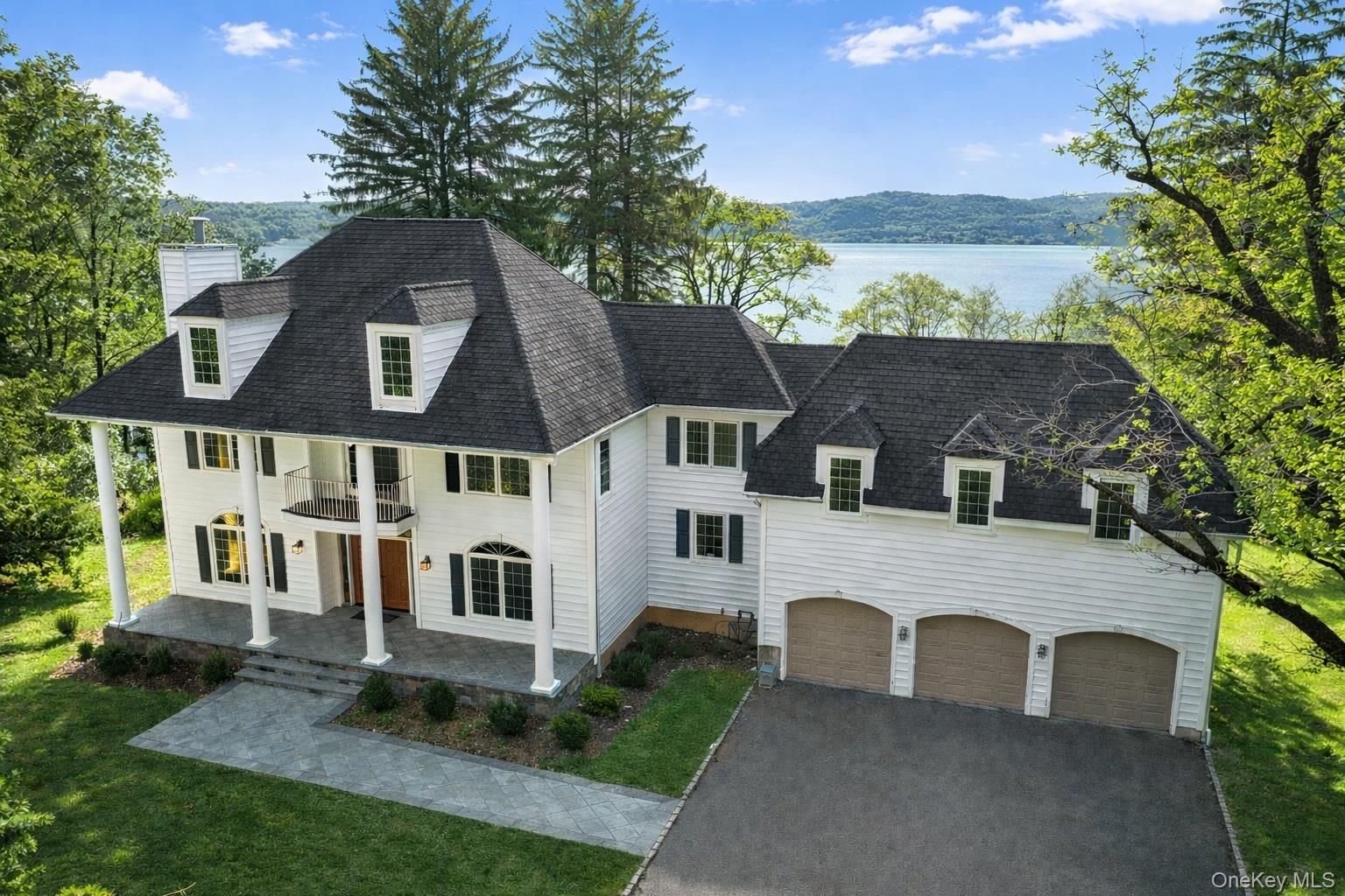 Front Photo of home with 3 car garage and amazing Hudson River Views