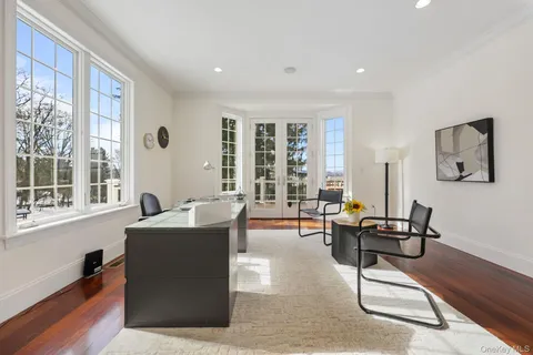 a view of a dining room with furniture wooden floor and chandelier