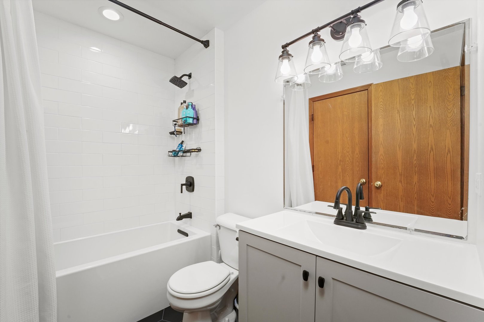 12554 Arbor Drive Alsip, IL 60803 - Photo 15 of 28 a bathroom with a sink a toilet and a shower curtain