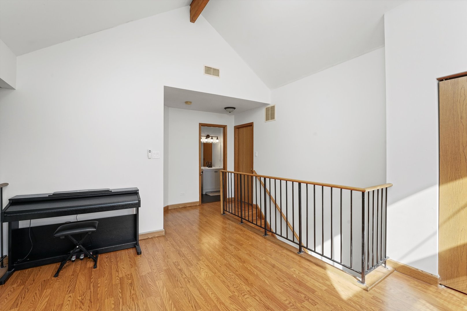 12554 Arbor Drive Alsip, IL 60803 - Photo 21 of 28 a hallway with a piano and wooden floor