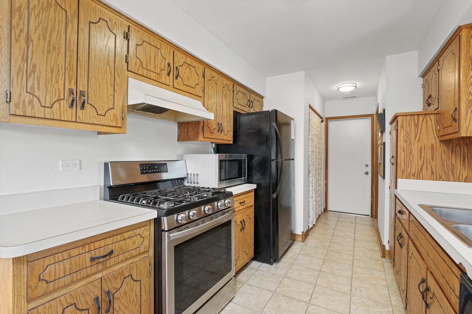 12554 Arbor Drive Alsip, IL 60803 - Photo 6 of 28 a kitchen with stainless steel appliances granite countertop a stove a refrigerator and a sink