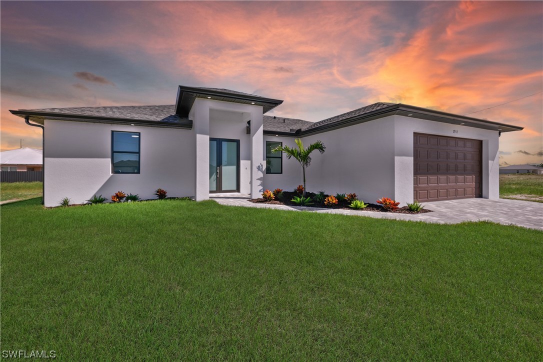 a front view of house with yard and green space