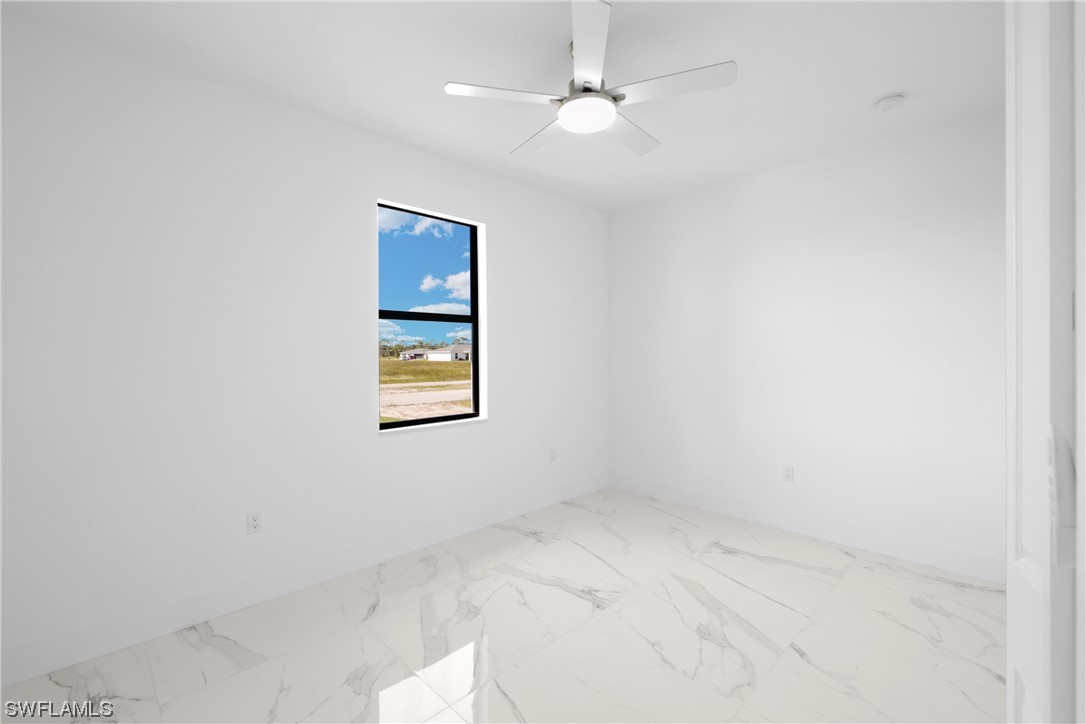2917 Nelson Road North Cape Coral, FL 33993 - Photo 14 of 25 an empty room with a window and ceiling fan