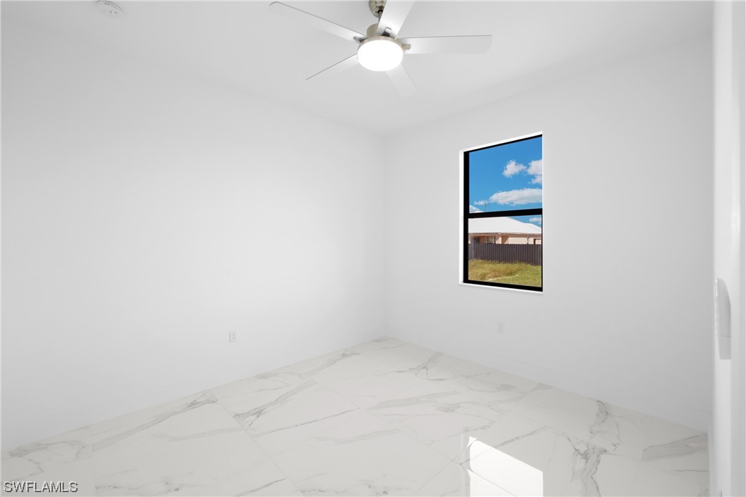 2917 Nelson Road North Cape Coral, FL 33993 - Photo 17 of 25 an empty room with windows and fan
