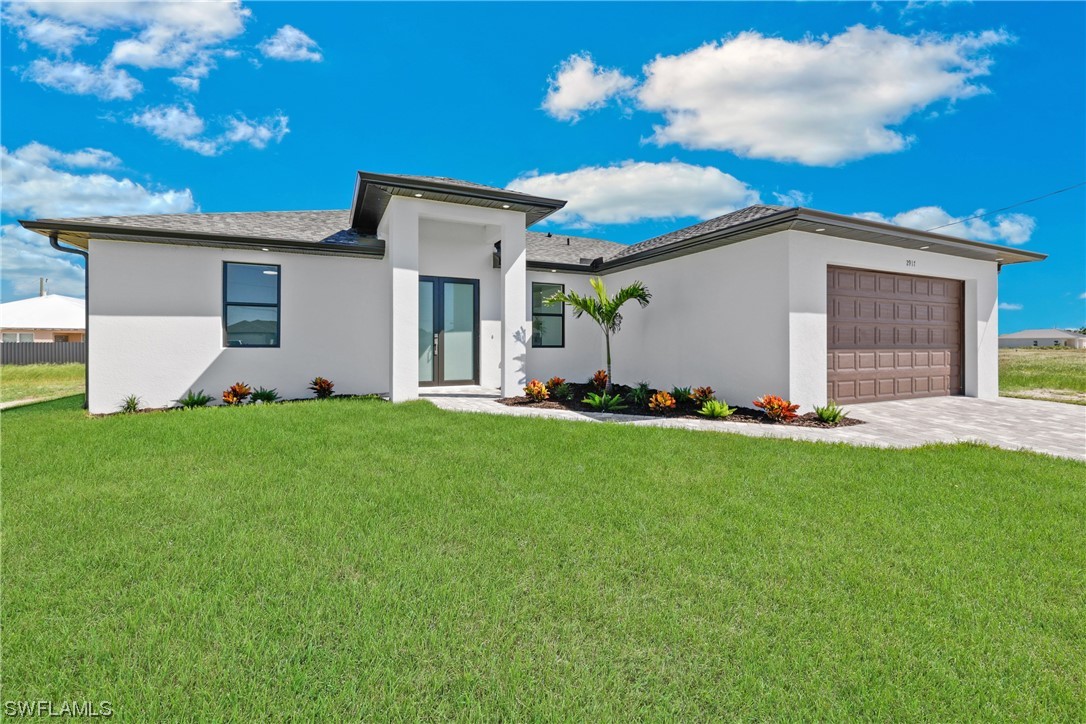 2917 Nelson Road North Cape Coral, FL 33993 - Photo 2 of 25 a front view of house with yard