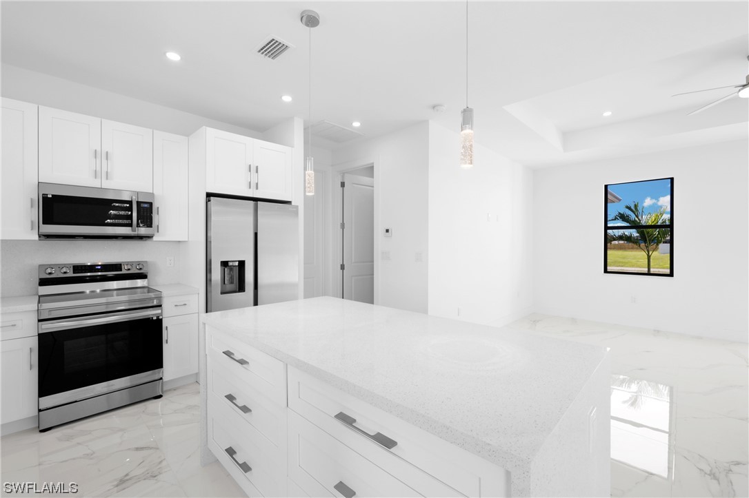2917 Nelson Road North Cape Coral, FL 33993 - Photo 21 of 25 a kitchen with stainless steel appliances a refrigerator sink and stove