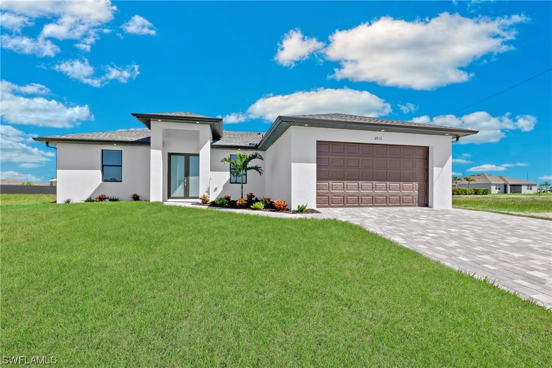 2917 Nelson Road North Cape Coral, FL 33993 - Photo 25 of 25 a front view of a house with a yard and garage