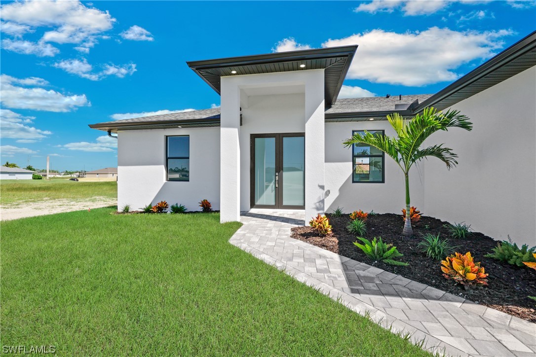 2917 Nelson Road North Cape Coral, FL 33993 - Photo 3 of 25 a front view of a house with garden