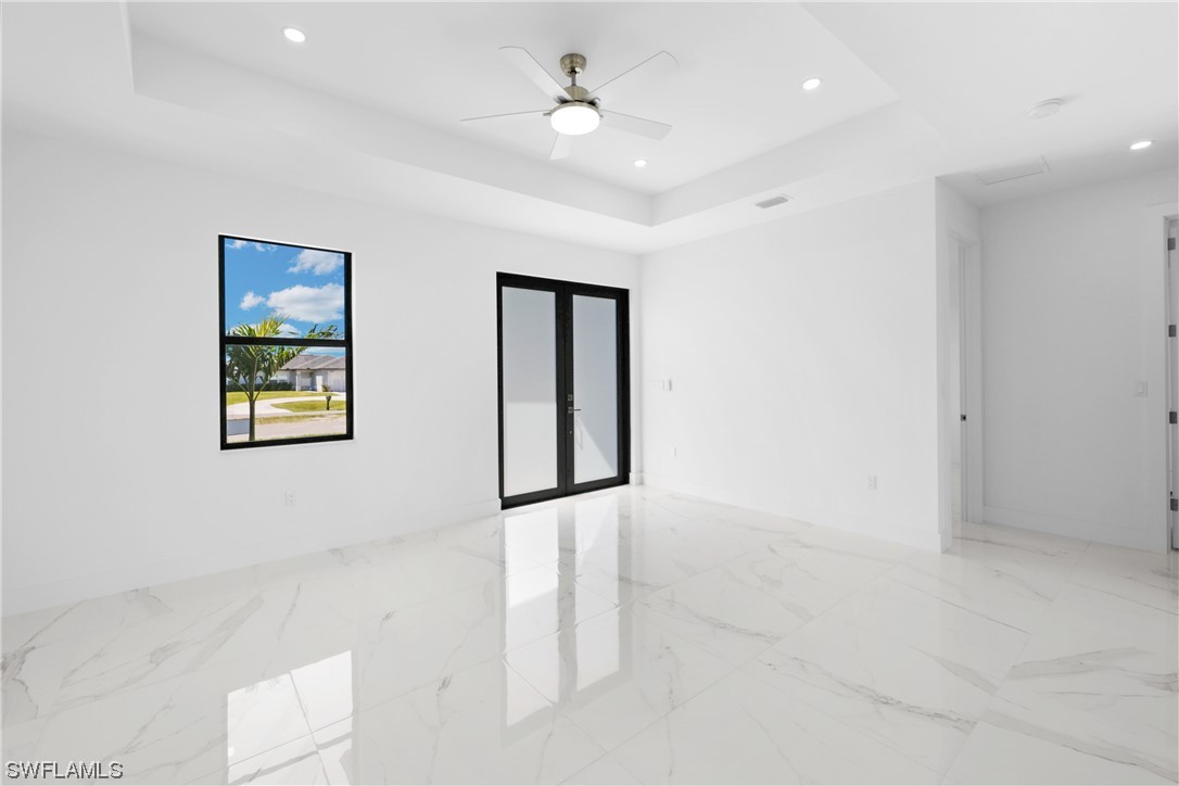 2917 Nelson Road North Cape Coral, FL 33993 - Photo 5 of 25 an empty room with windows and cabinet