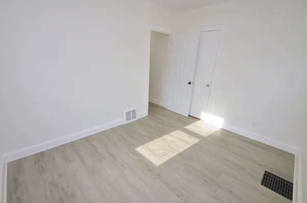 an empty room with wooden floor