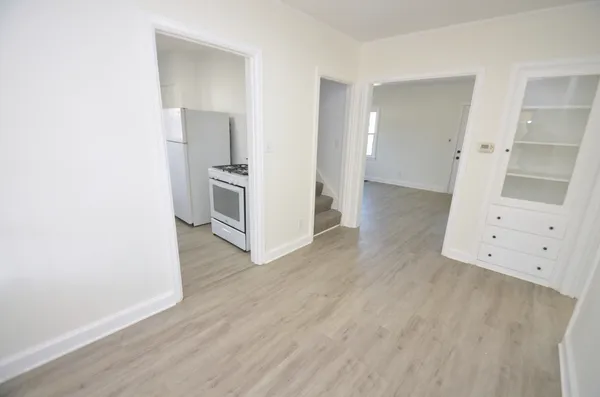 a view of a kitchen with wooden floor