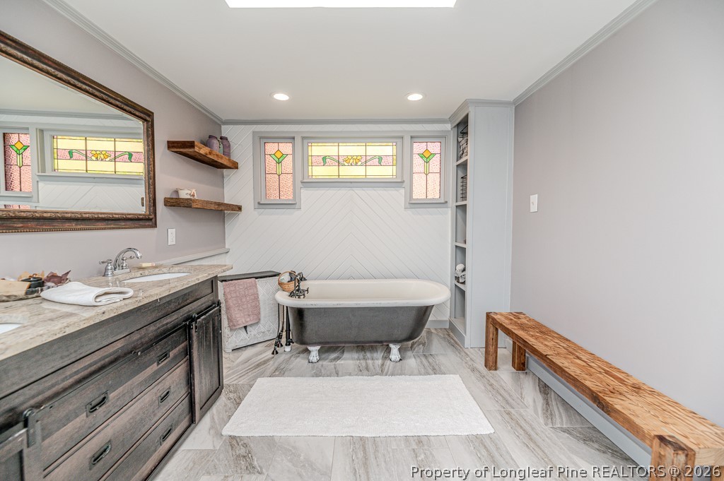 509 Carthage Street Cameron, NC 28326 - Photo 22 of 43 a spacious bathroom with a granite countertop sink and a mirror