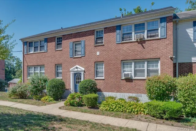 front view of brick house with a yard