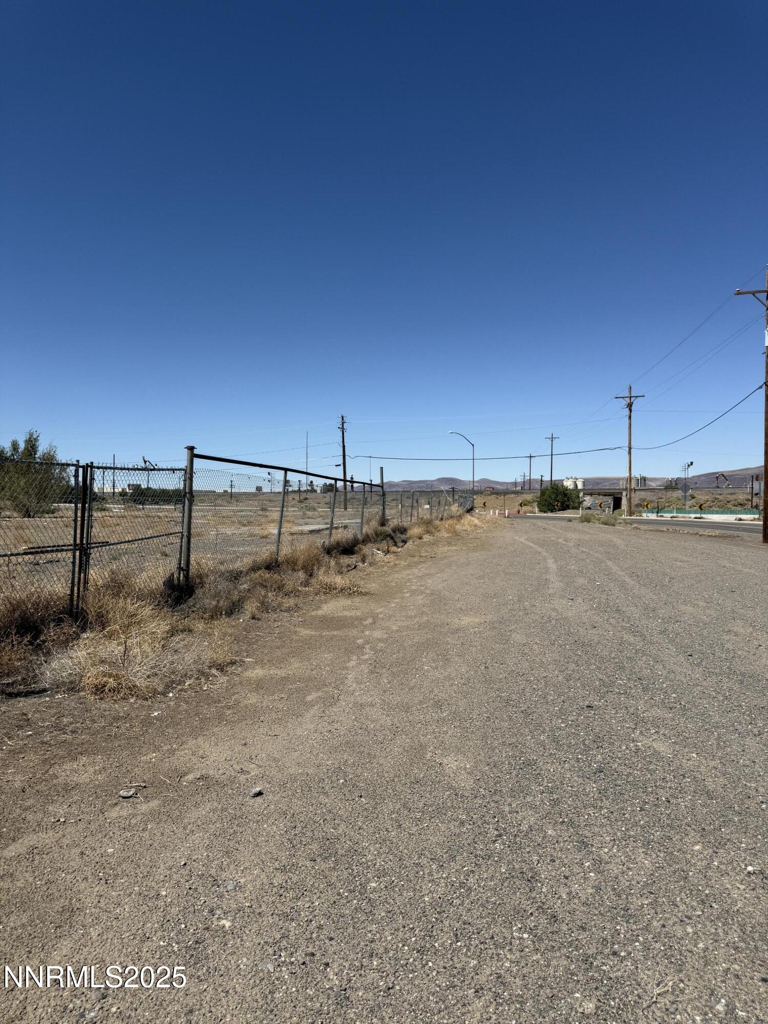 825 Mesa Drive Fernley, NV 89408 - Photo 4 of 20 a view of a yard with wooden fence