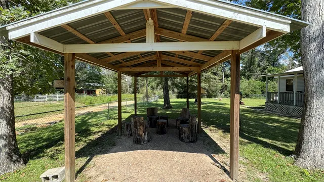 a view of a porch with furniture and backyard