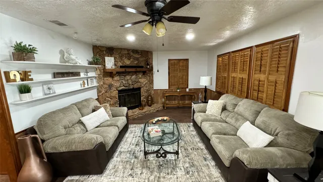 a living room with furniture fireplace and a flat screen tv